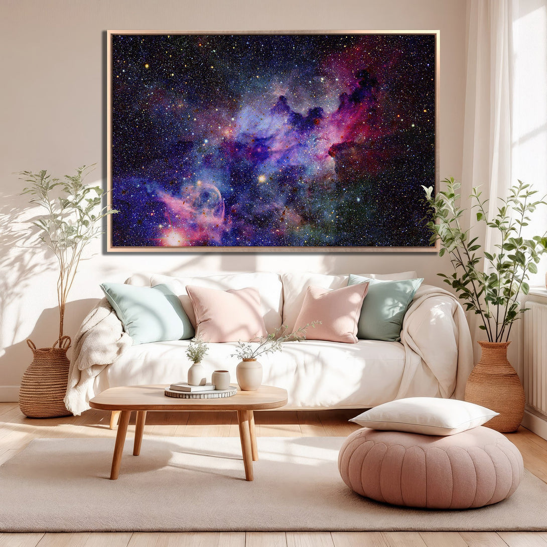 Framed Wall Art: Stunning galaxy Canvas Print in a living room. Features vibrant blues, purples, and pinks, adding a cosmic touch to any space.