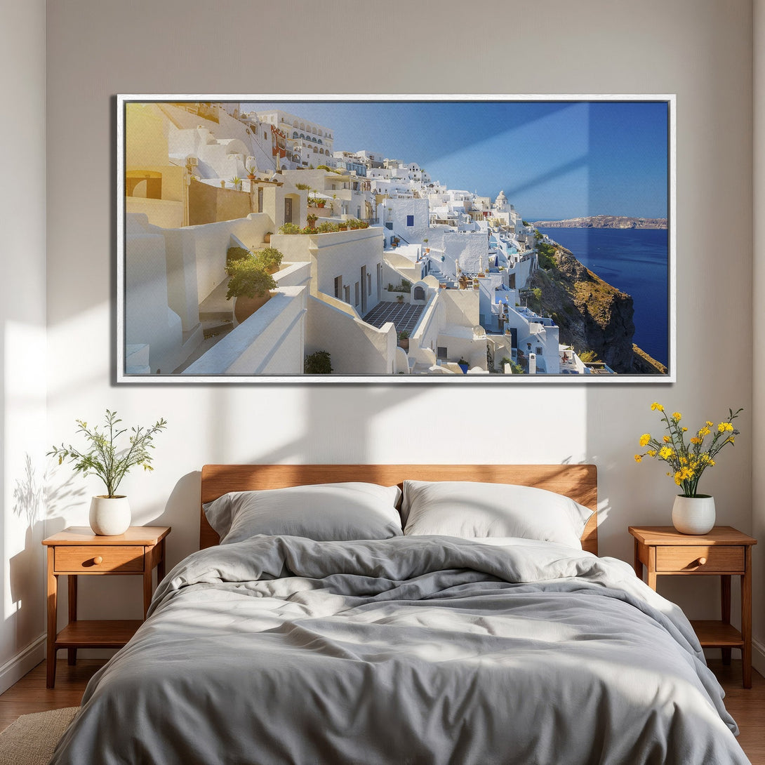 Framed Wall Art featuring a stunning Santorini landscape. Coastal scene in white, blue, and gold hues. Perfect for adding a touch of wanderlust to your bedroom decor.