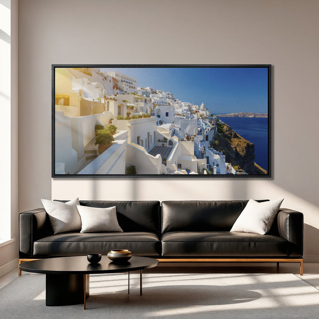 Framed Wall Art of Santorini, Greece. Coastal landscape Canvas Print with white buildings, blue sea, and warm tones. Elevate your home decor!