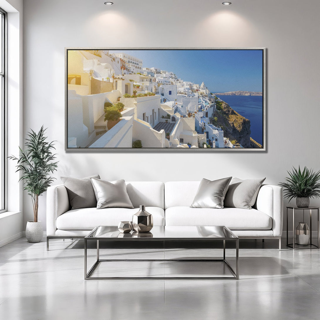 Framed Wall Art of Santorini village. Coastal landscape art with white buildings, blue sea, and a bright, sunny palette. Perfect home decor.