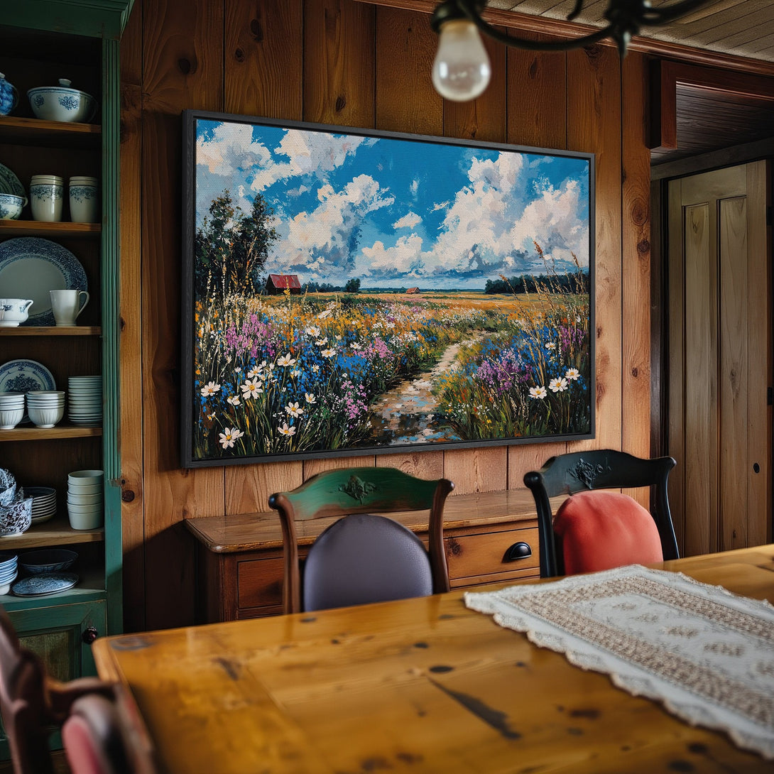 Framed Wall Art: Impressionistic landscape painting with blue sky, wildflowers, and a path. Earthy tones and vibrant colors bring nature indoors.