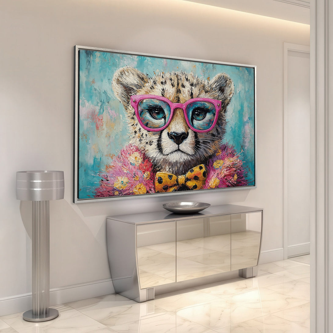 Framed Wall Art: Playful cheetah portrait in vibrant colors. Modern art with pink glasses, turquoise background, and a pop of yellow. Add a touch of fun!