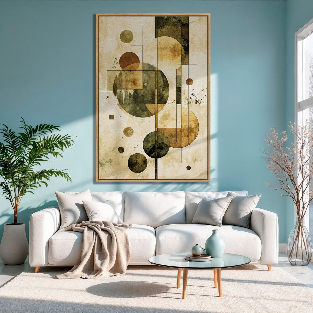Framed Wall Art featuring abstract geometric shapes in earthy tones. Modern canvas print adds a stylish touch to a living room with a blue wall.