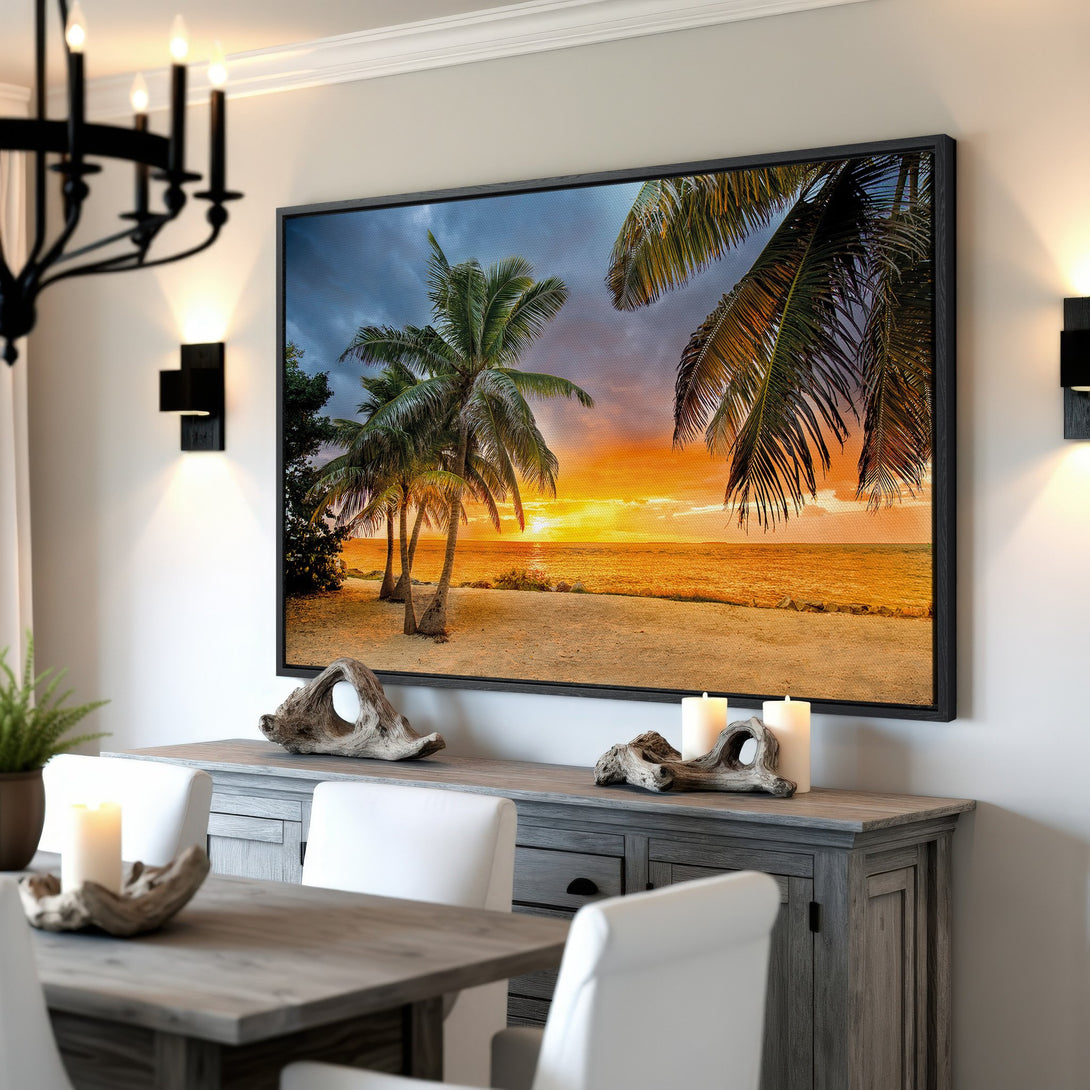 Framed Wall Art of a tropical sunset with palm trees. Warm, vibrant colors of orange, yellow, and blue. Coastal decor for your home.