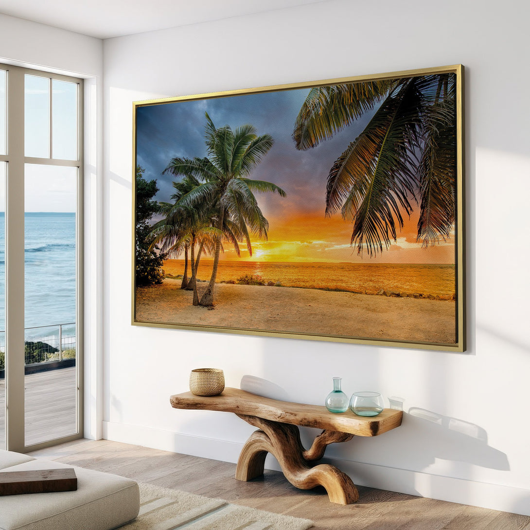 Canvas Print of a tropical beach sunset with palm trees. Warm, vibrant colors bring a coastal, relaxing vibe to your home decor.