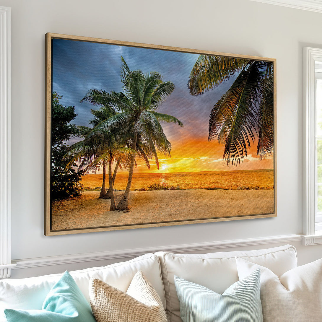 Framed Wall Art: Tropical beach sunset canvas print with palm trees and warm orange, yellow, and blue hues. Perfect for coastal decor.