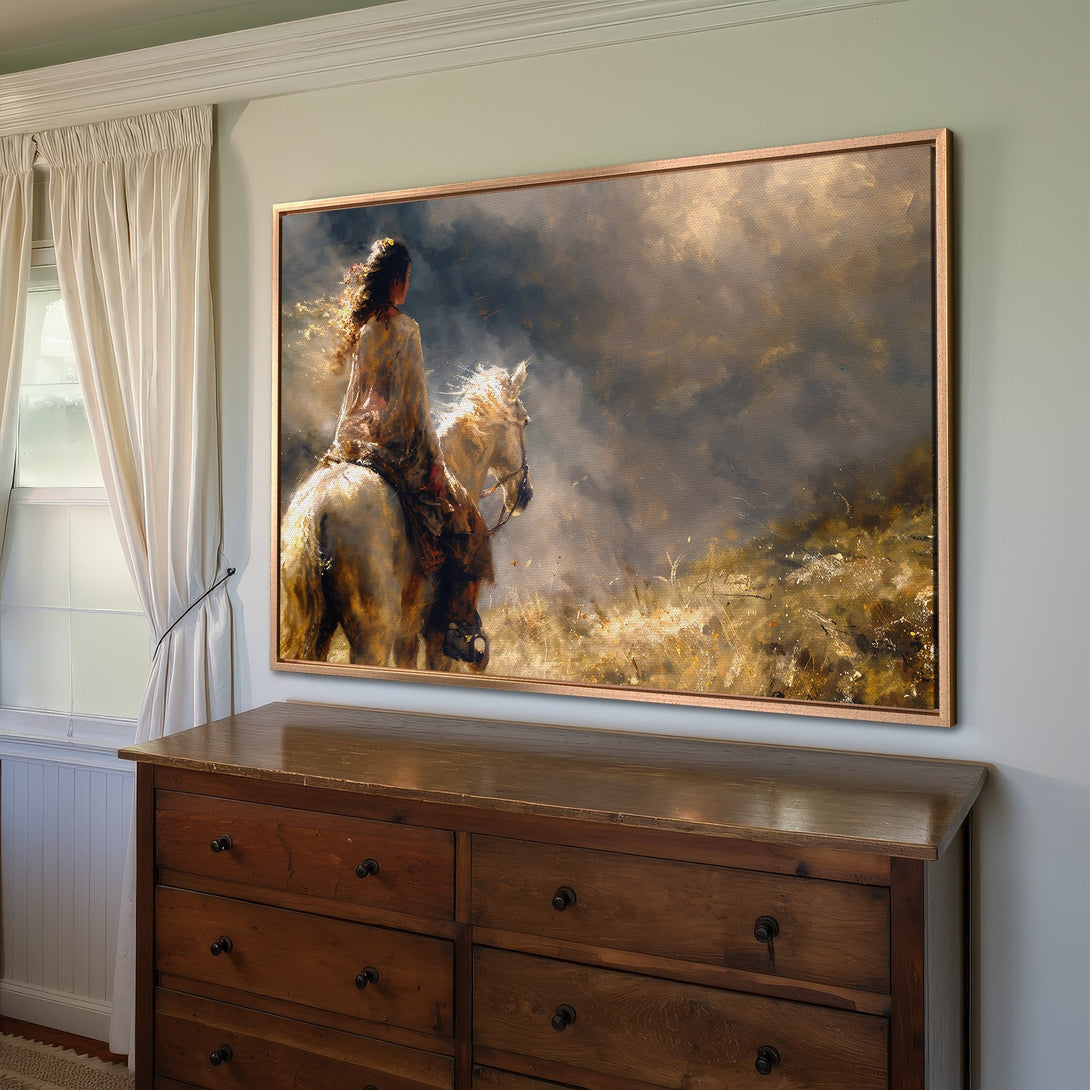 Framed Wall Art of Native American woman on horseback. Artistic style, warm earth tones and dramatic sky. Perfect for home decor.