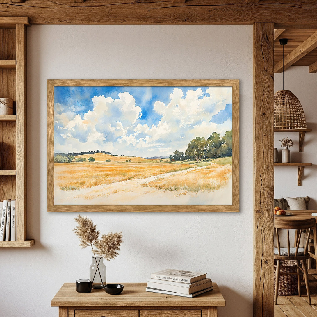 Framed Poster of a watercolor landscape painting. Features blue sky, golden fields, and trees. Earthy tones create a calming aesthetic.