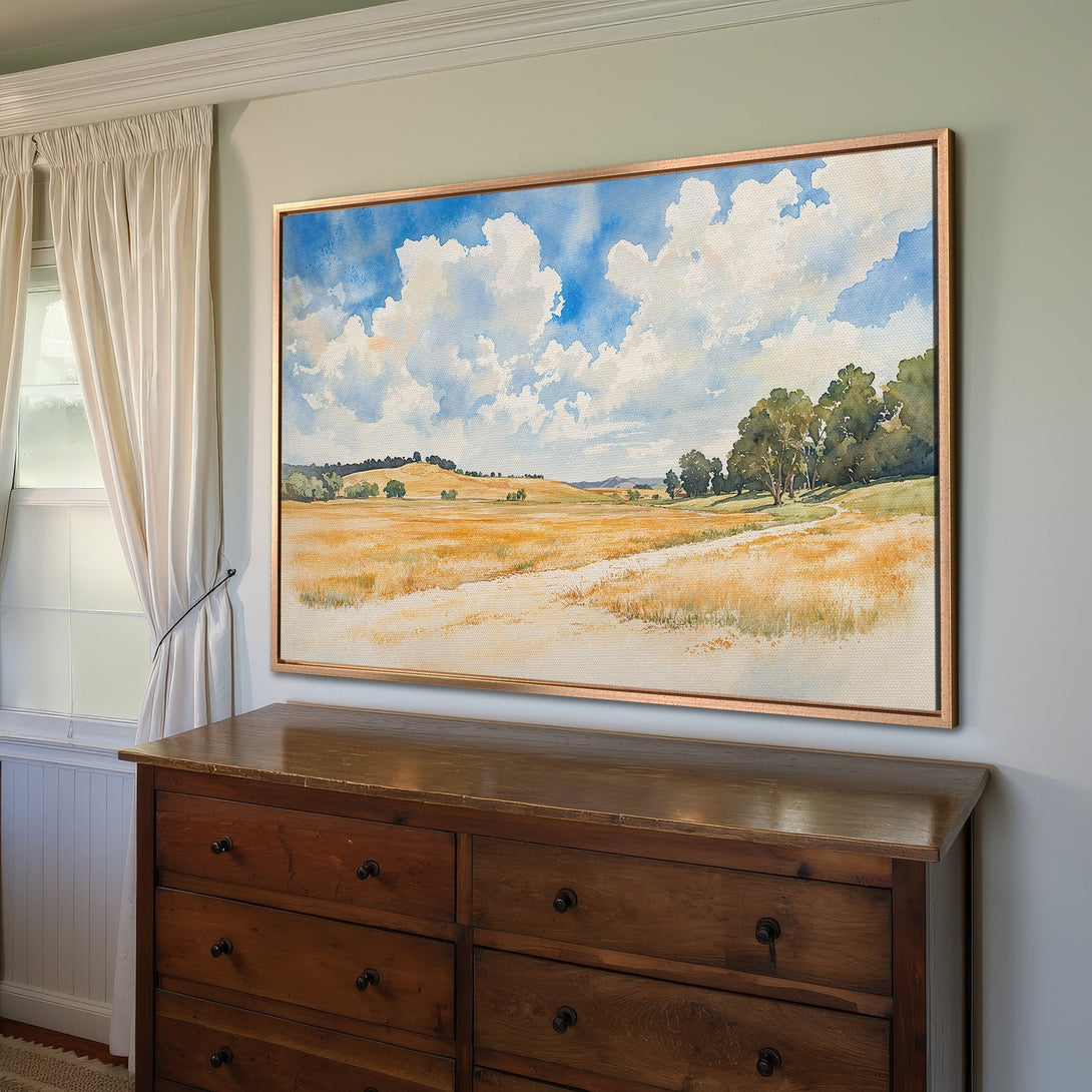 Framed Wall Art: Watercolor landscape Canvas Print. Warm, inviting colors of blue sky, golden fields, and green trees. Perfect for adding a touch of nature to your home.