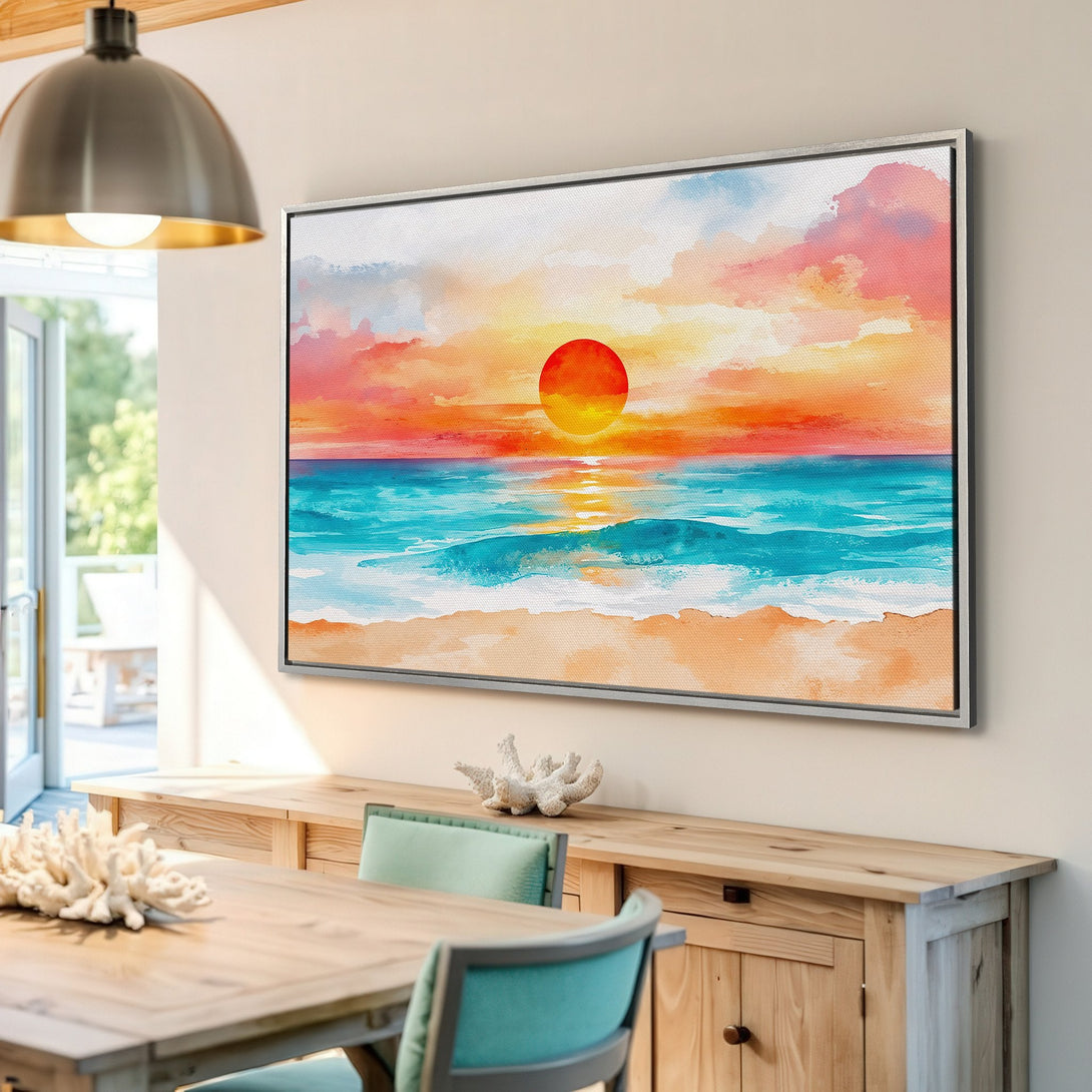 Framed Wall Art: Watercolor sunset canvas print in a coastal interior. Features vibrant orange, turquoise, and pink hues. Perfect beach decor!