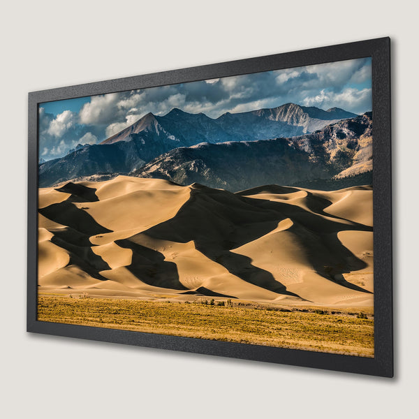 Framed Poster featuring a desert landscape with sand dunes and mountains, warm color palette. Perfect wall art!