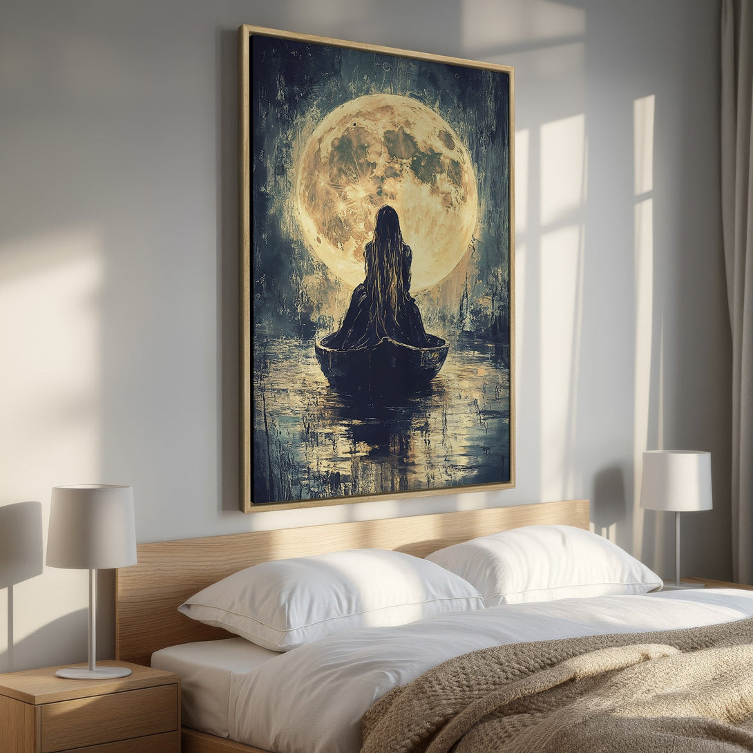 Framed Wall Art featuring a woman in a boat before a moon. Moody, artistic style with a dark blue, gold, and neutral color palette. Perfect bedroom decor.