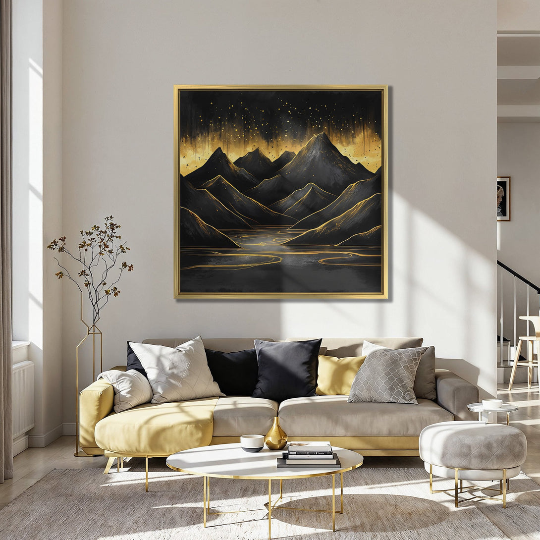 Canvas Print of a mountain landscape in black and gold, displayed in a cozy interior with red chairs. Modern art with a warm, luxurious feel.