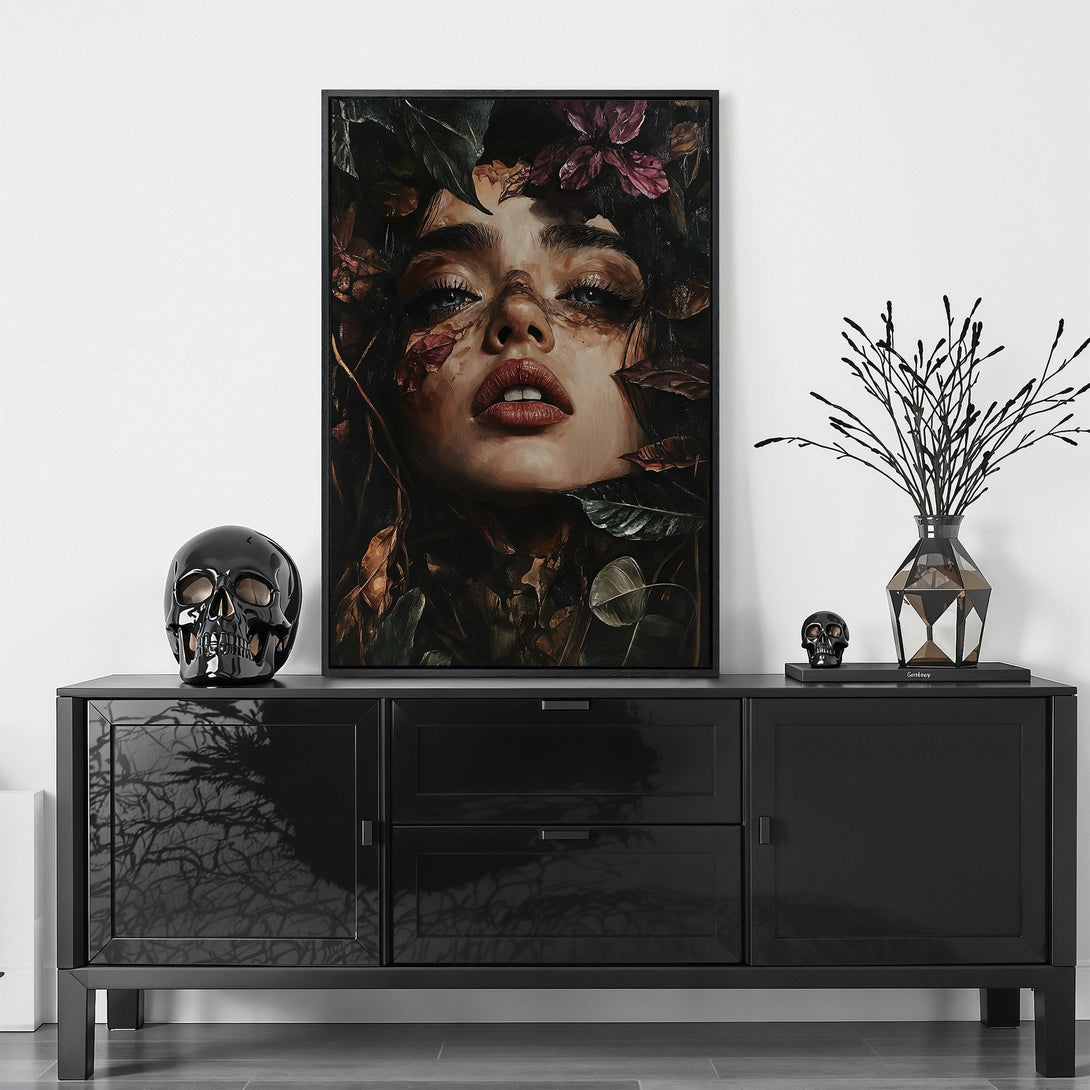 Framed Wall Art featuring a woman's face surrounded by leaves, in a dark, moody color palette. Perfect for adding an artistic touch to any space.