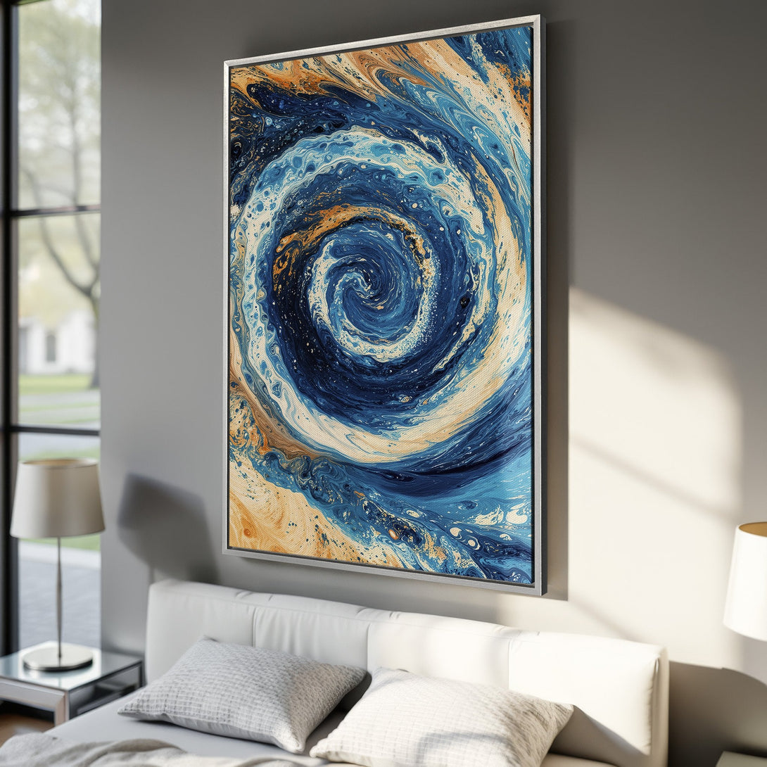 Framed Wall Art featuring an abstract swirling design in shades of blue, gold, and white. Modern art canvas print adds a touch of elegance to any space.