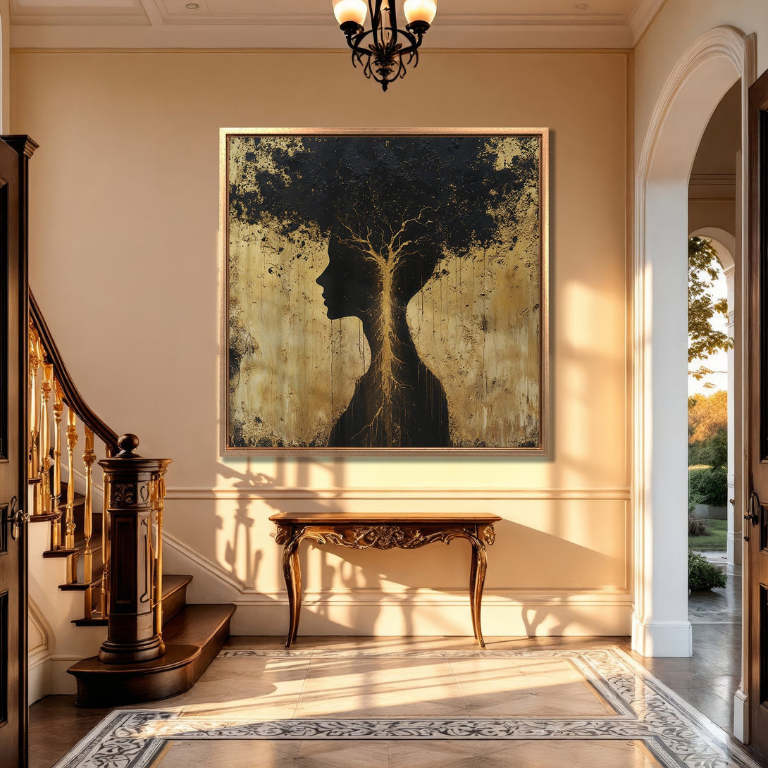 Framed Wall Art featuring a silhouette woman-tree in gold and black, displayed in an elegant interior. Modern abstract art for stylish home decor.