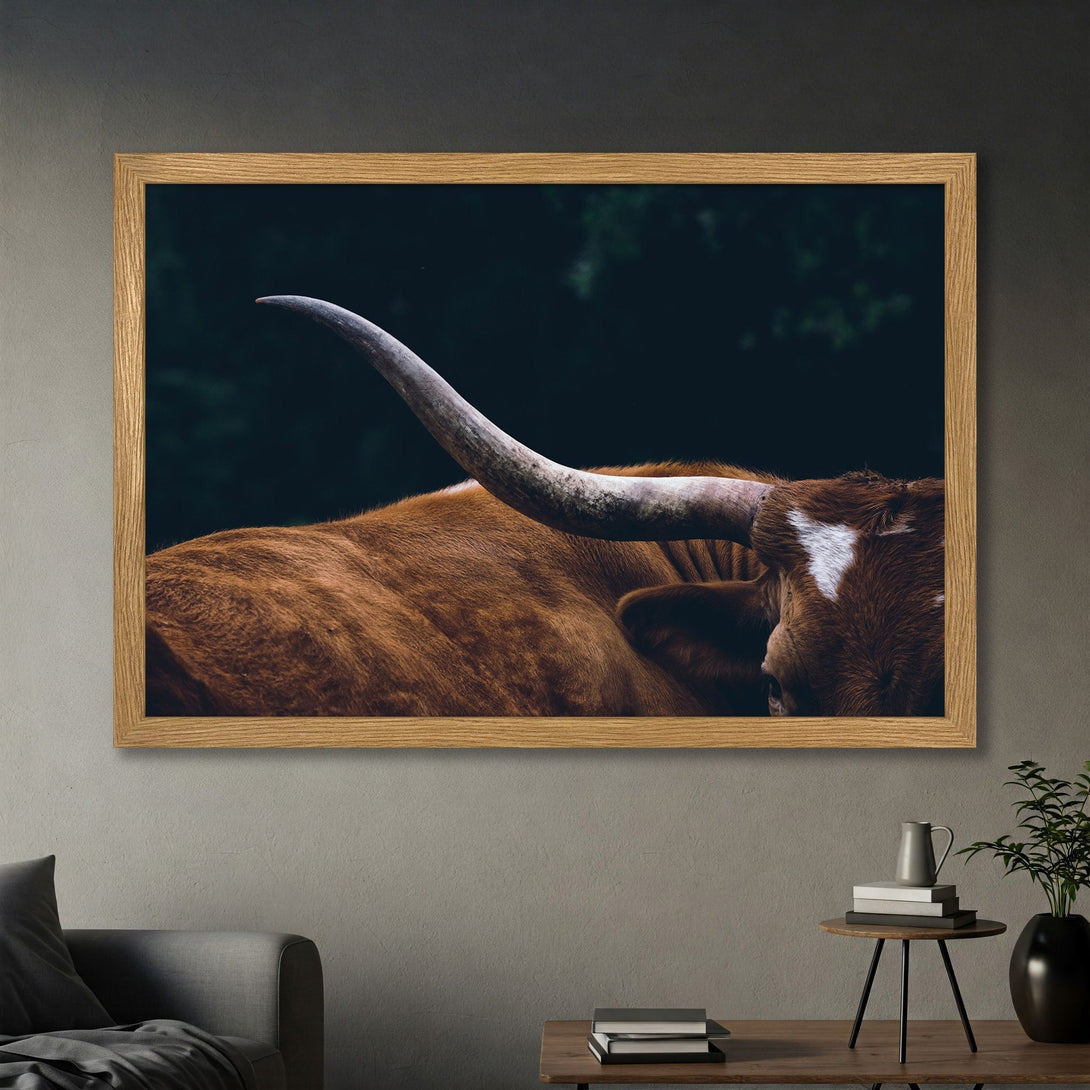Framed Poster of a longhorn bull. Rustic style, warm brown tones against a dark background. Perfect wall art for your home.