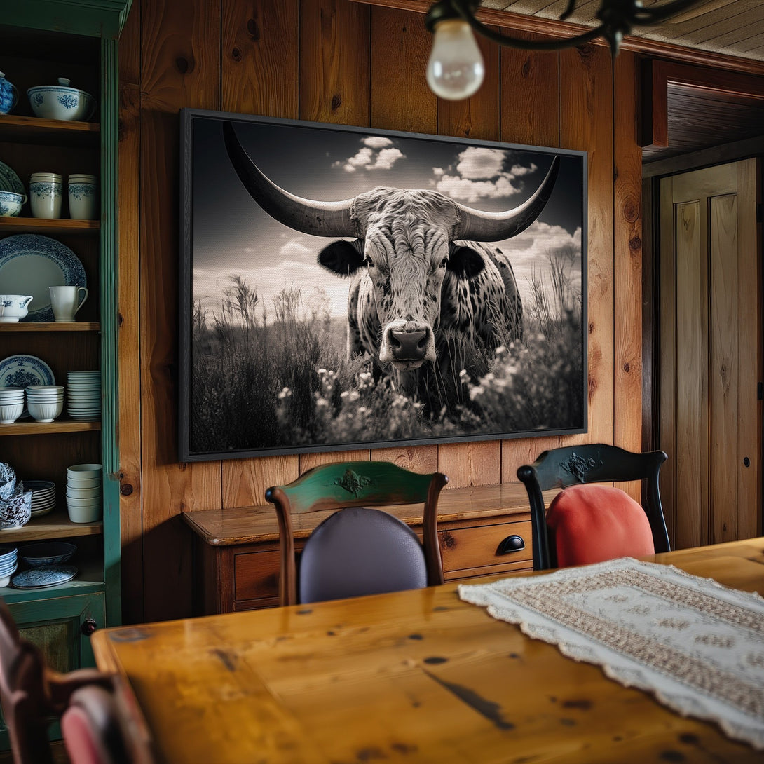 Framed Wall Art: Rustic black and white canvas print of a longhorn bull in a field. Perfect farmhouse decor with a neutral color palette.