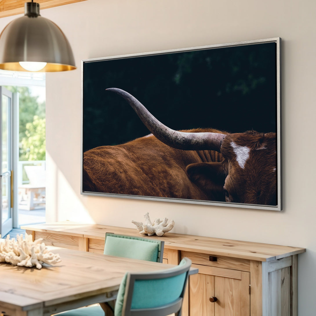 Framed Wall Art featuring a close-up of a Texas Longhorn. Rustic style with warm brown and dark green tones. Perfect for adding a touch of nature to your home.