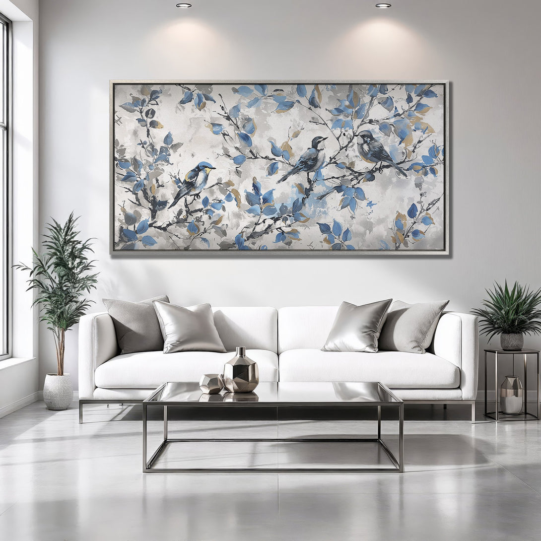 Framed Wall Art featuring birds on branches with blue and gold leaves. Modern, elegant canvas print in a neutral color palette. Perfect for any interior.