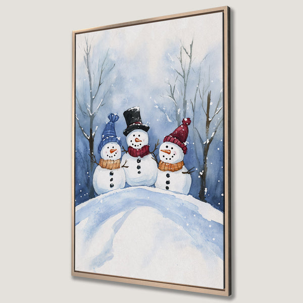 Framed Wall Art featuring a watercolor painting of three snowmen in a winter scene. Blue and white color palette, perfect for holiday decor.