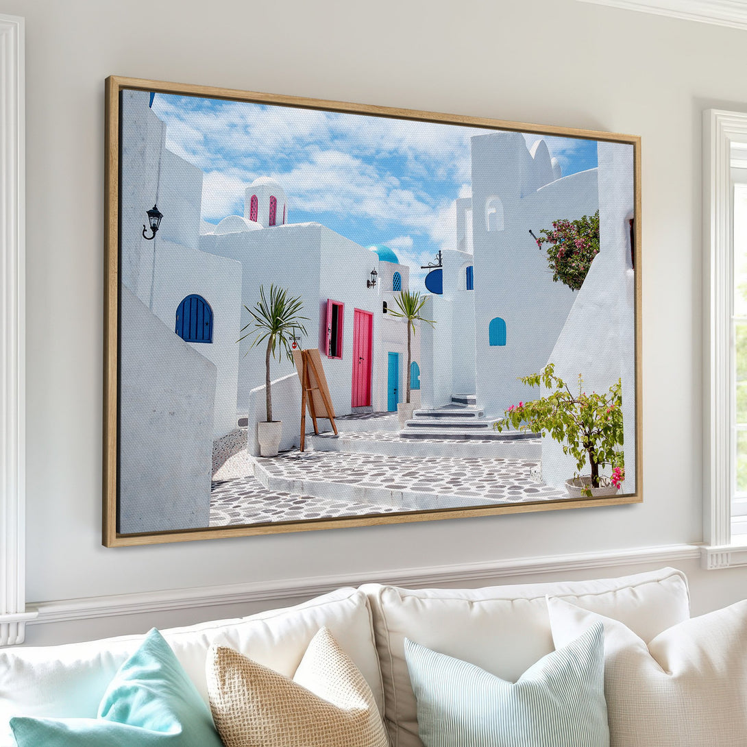 Framed Wall Art: Santorini scene in blue, white, and pink. Mediterranean style Canvas Print adds a touch of wanderlust to your home decor.