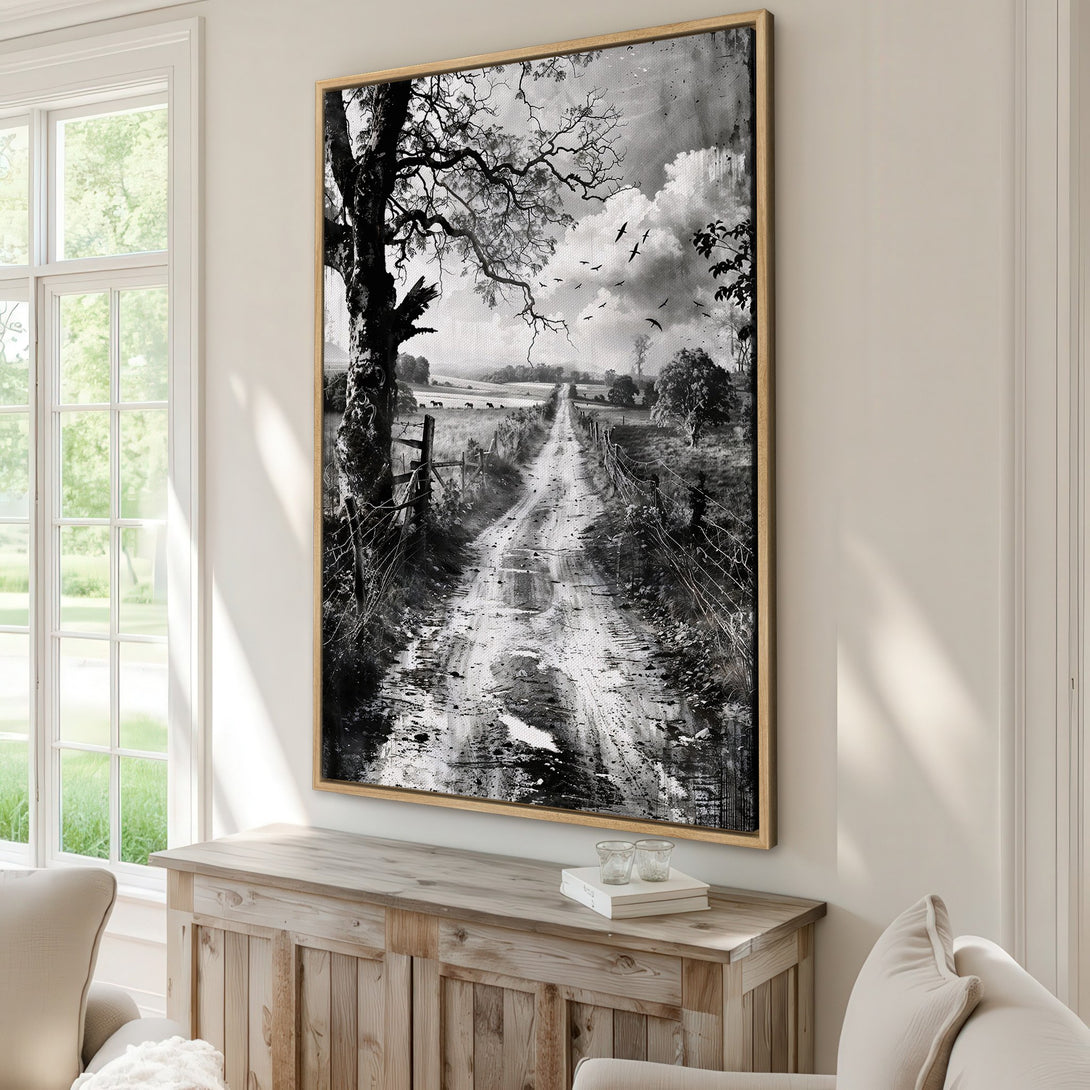 Framed Wall Art featuring a black and white landscape with a rural road, tree, and birds. Rustic style with a monochromatic color palette, perfect for home decor.