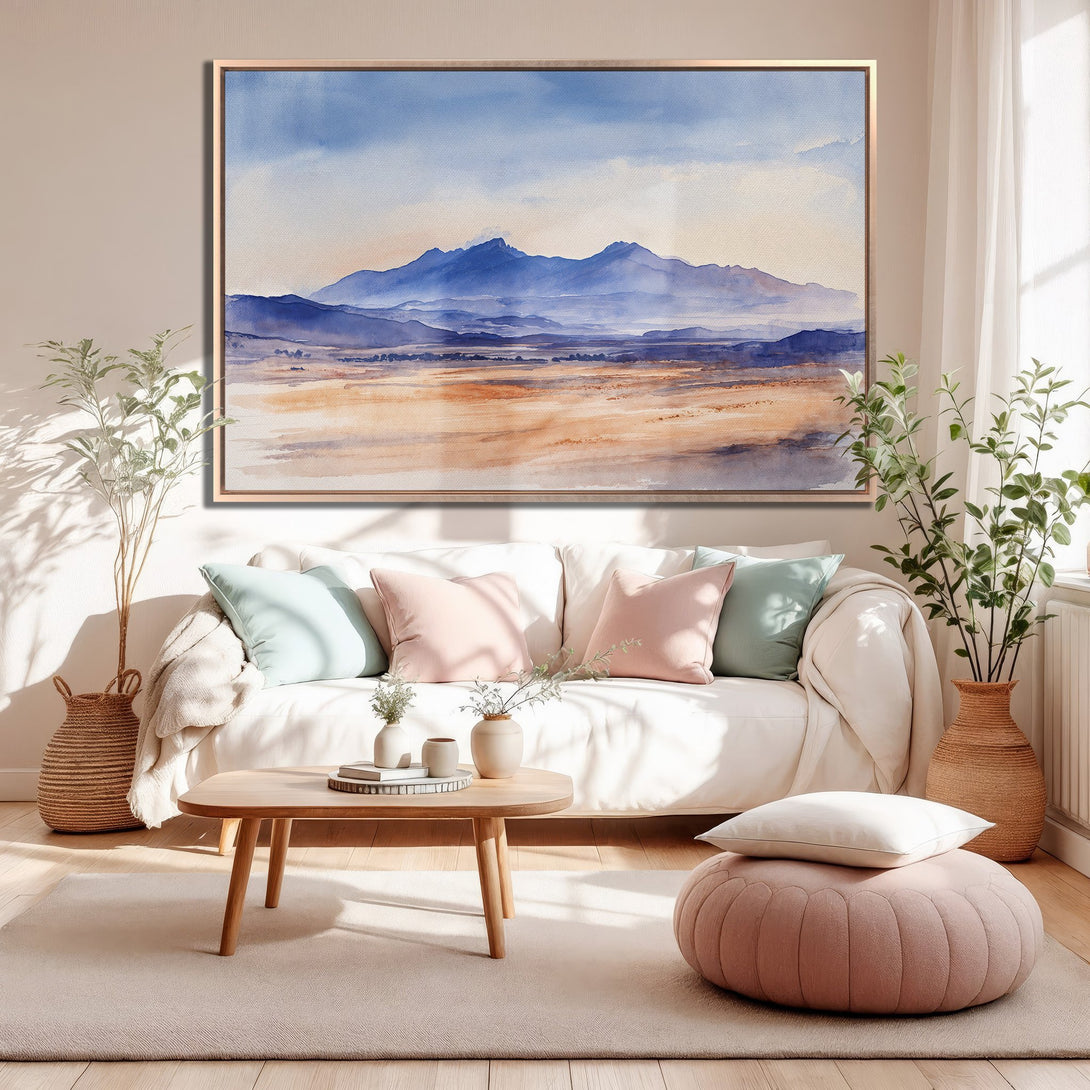 Framed Wall Art: Watercolor mountain landscape canvas print in blue and beige tones, perfect for adding a touch of serenity to your living room.
