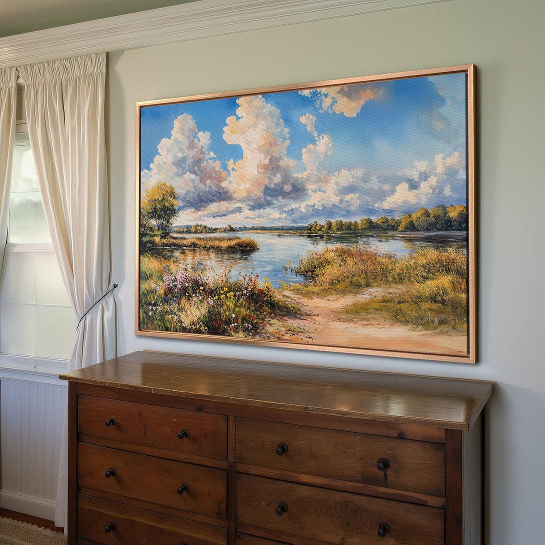 Framed Wall Art: Landscape Canvas Print with a serene river scene, featuring a blue sky, warm earth tones, and a touch of vibrant wildflowers.