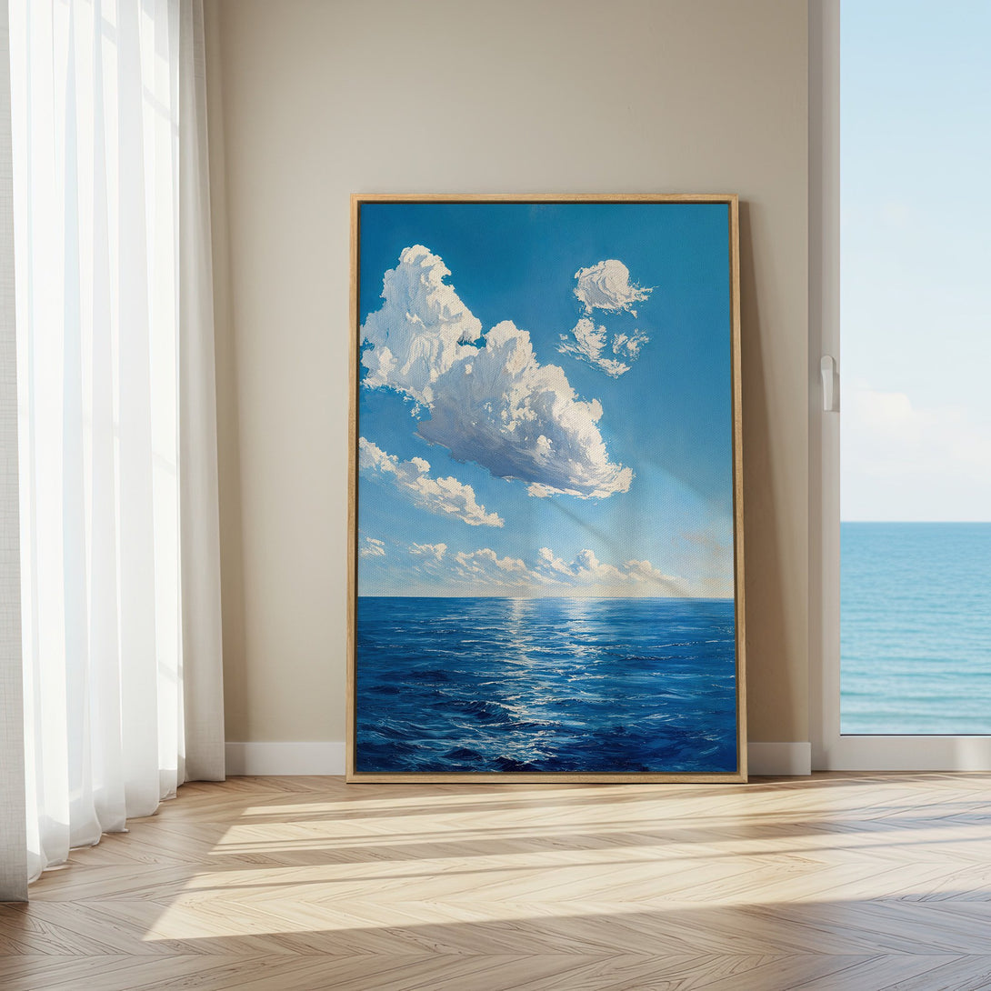 Framed Wall Art featuring a serene ocean and cloudscape painting in blue and white hues. Perfect for coastal decor and creating a calming atmosphere.