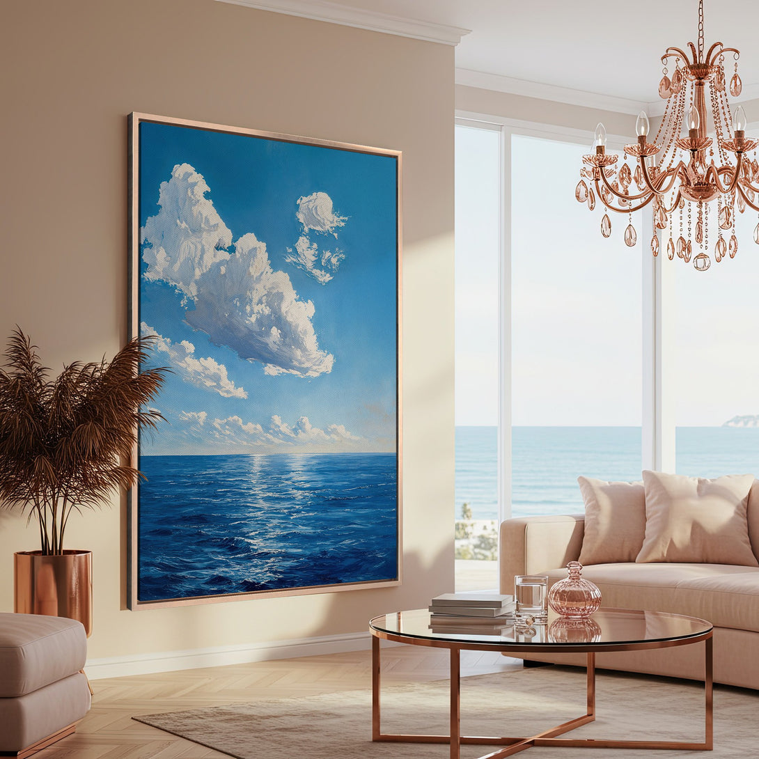 Framed Wall Art: Serene ocean scene canvas print in blue and white, displayed in a modern living room. Coastal art with a calming, artistic style.
