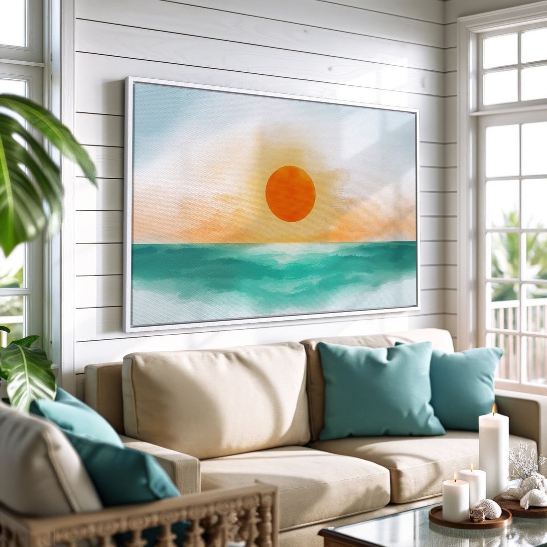 Framed Wall Art: Coastal sunset canvas print in a modern living room. Watercolor style artwork with orange, teal, and neutral tones. Perfect for home decor.