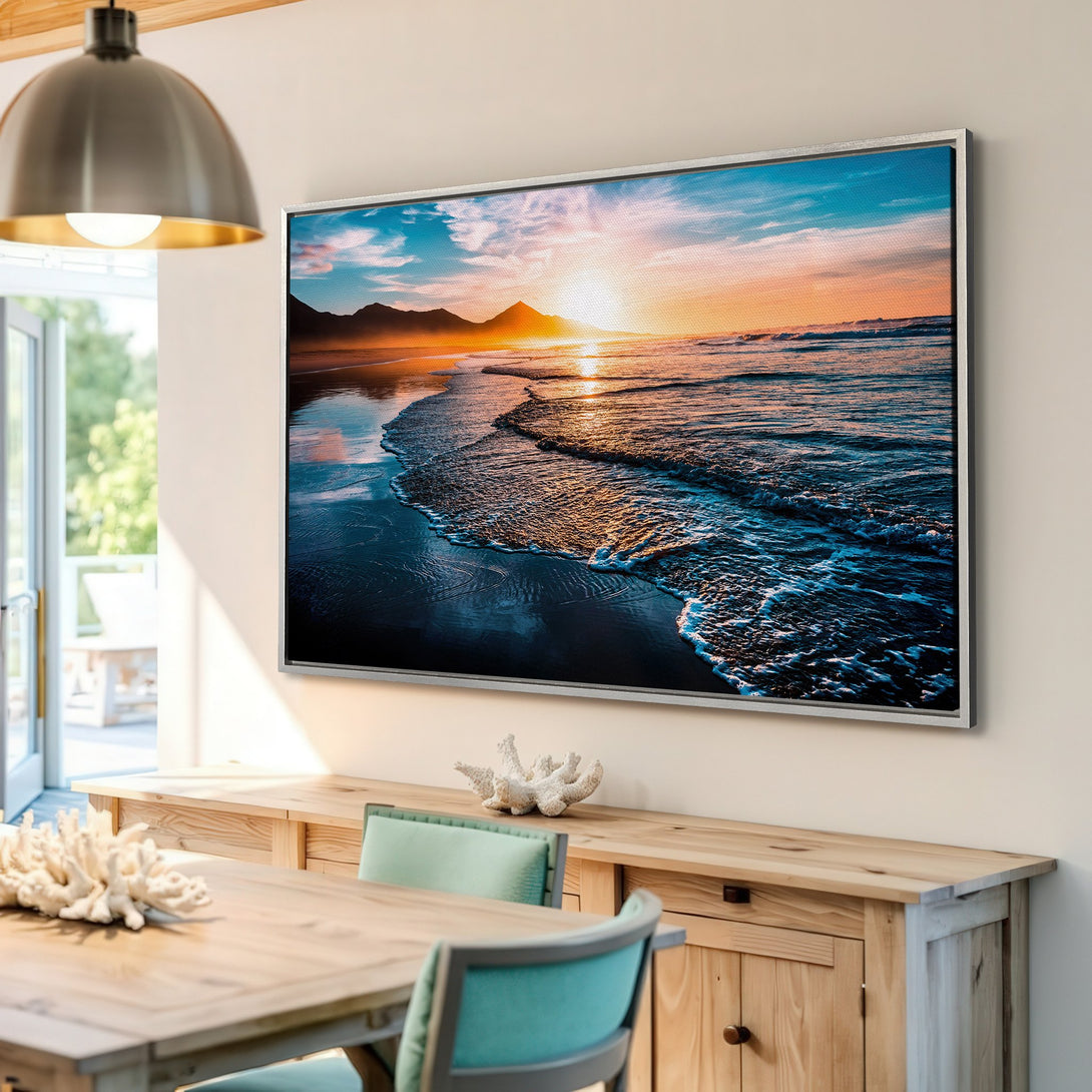 Framed Wall Art: Stunning beach sunset canvas print in a modern interior. Features a vibrant blue, orange, and teal color palette, perfect for coastal decor.