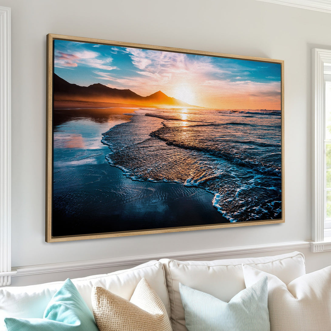 Framed Wall Art of a stunning beach sunset. Coastal style canvas print with vibrant blues, oranges, and gold hues, perfect for any home decor.