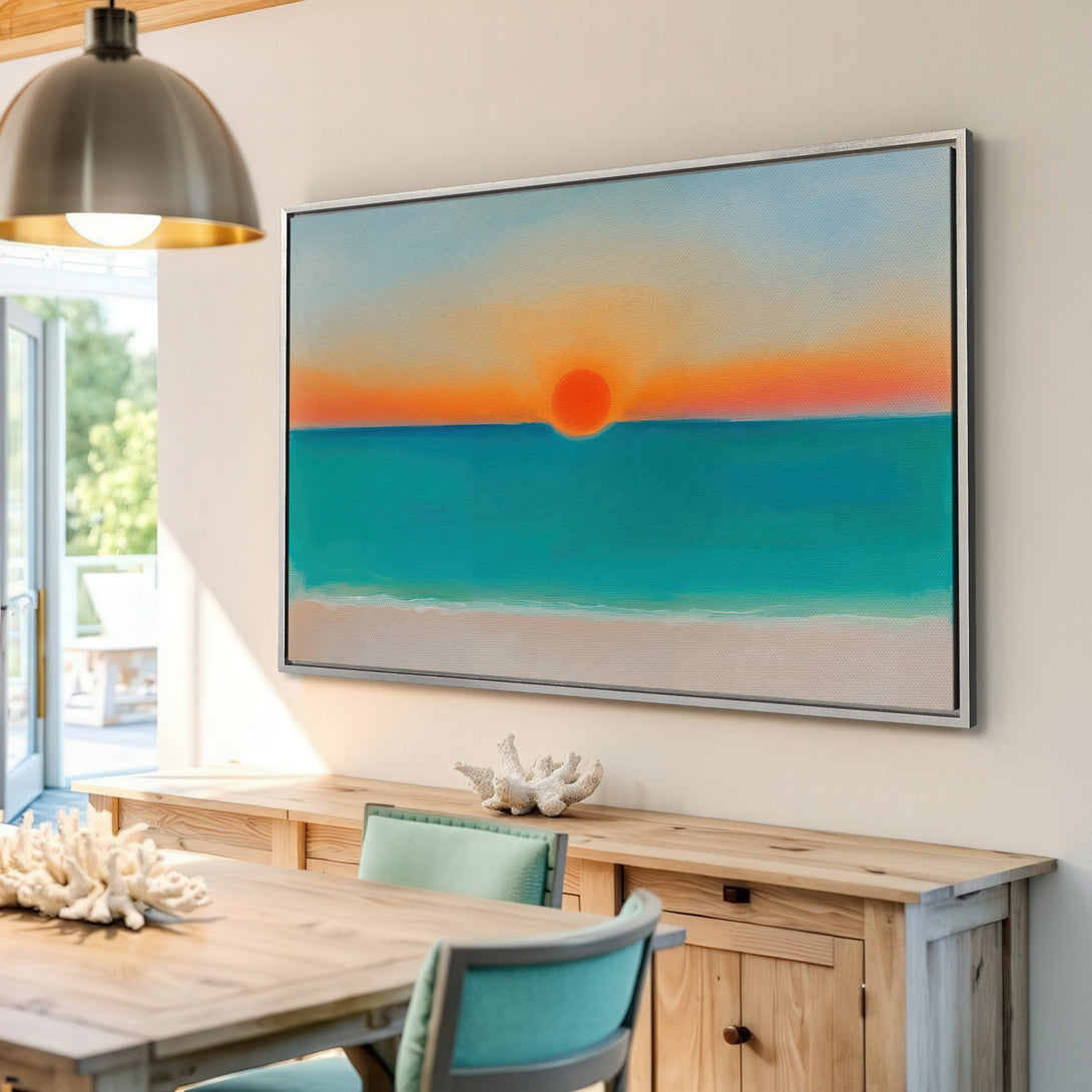 Framed Wall Art Canvas Print of a vibrant sunset over the ocean. Coastal style art with a warm orange, teal, and neutral color palette.
