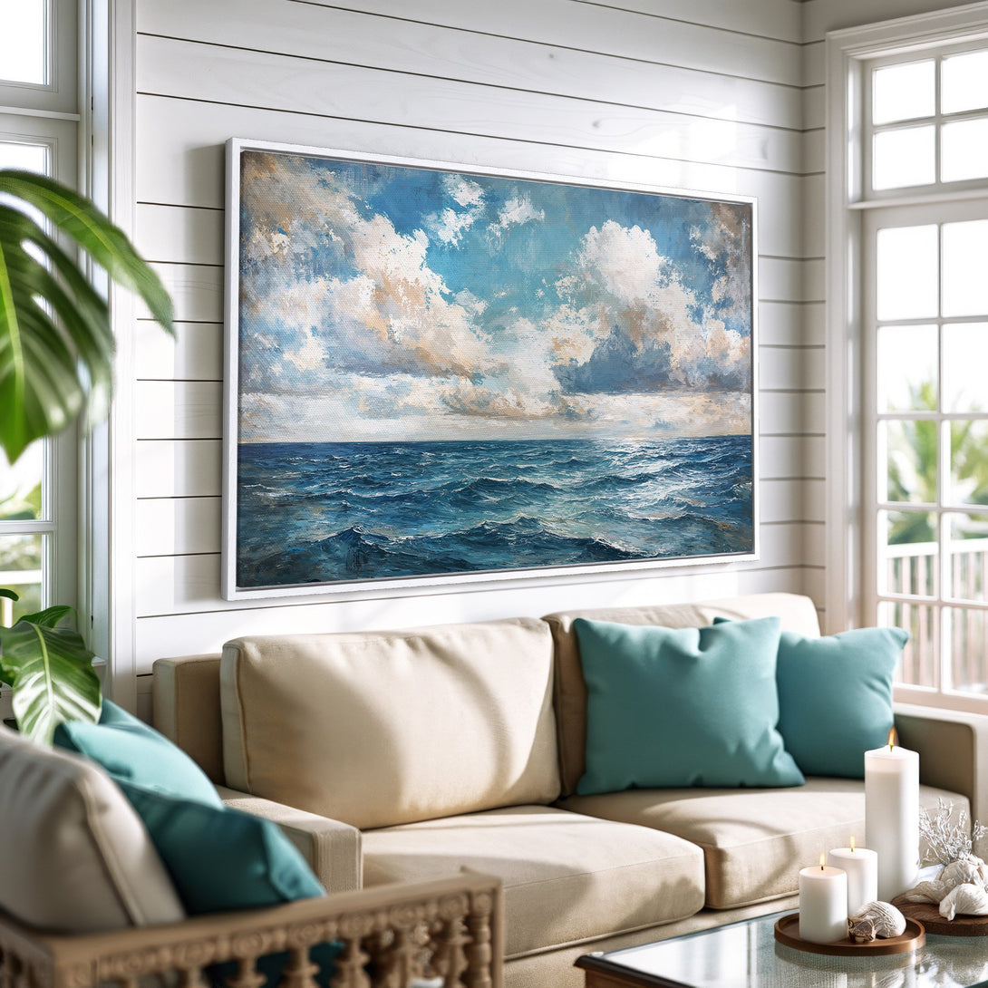 Framed Wall Art: Ocean view canvas print in a coastal living room. Blue and white seascape painting adds a calming touch to any space.