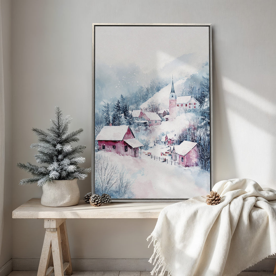 Framed Wall Art featuring a winter village scene in watercolor style. Soft blues, pinks, and whites create a cozy, inviting aesthetic for your home decor.
