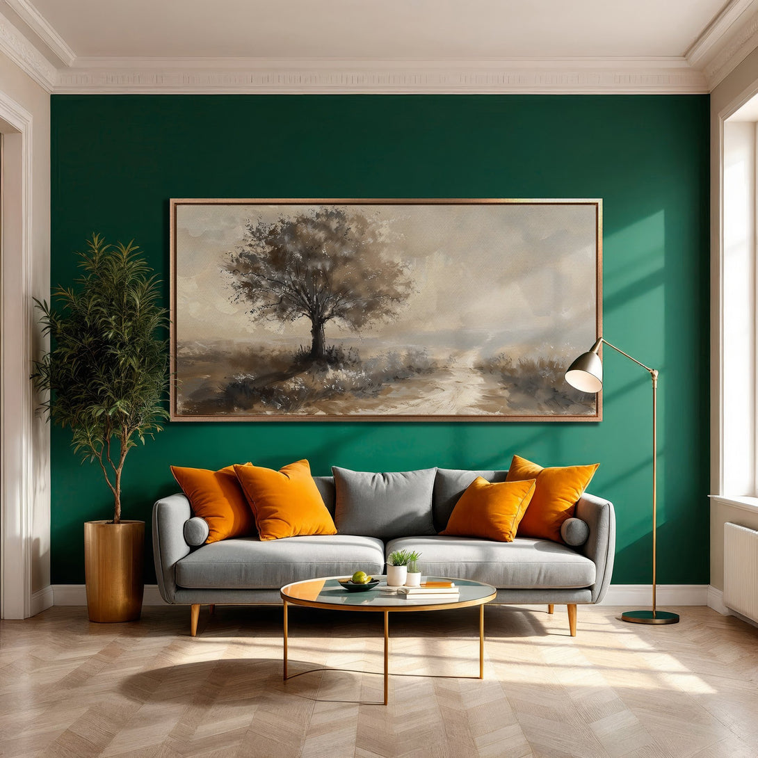 Framed Wall Art featuring a serene tree landscape in neutral tones. Modern interior with a green wall, gray sofa, and orange accents.
