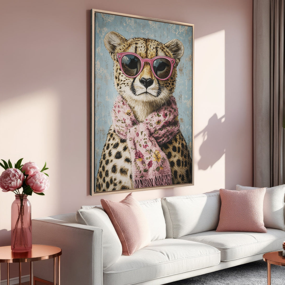 Framed Wall Art: Stylish cheetah portrait with pink sunglasses and scarf. Pastel color palette adds a chic touch to any room. Shop now!