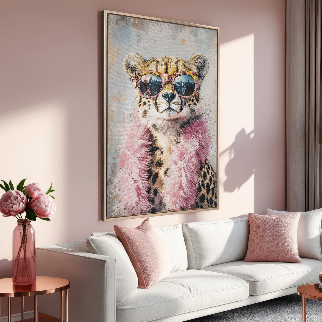 Framed Wall Art featuring a stylish cheetah wearing sunglasses and a pink boa. Perfect for adding a touch of glam to your home decor. Soft pink palette.