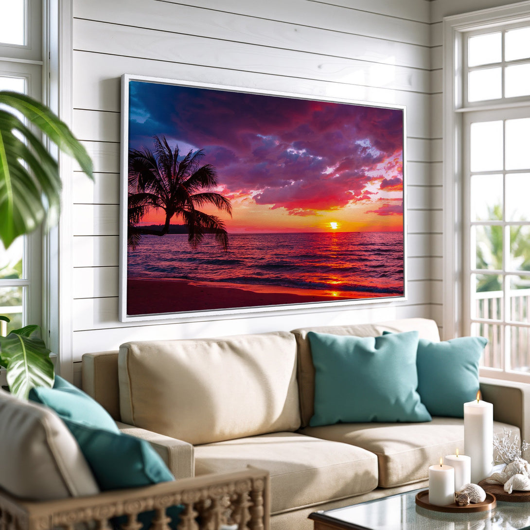 Framed Wall Art: Tropical sunset canvas print with vibrant red, orange, and blue hues. Coastal decor featuring a palm tree silhouette over the ocean.