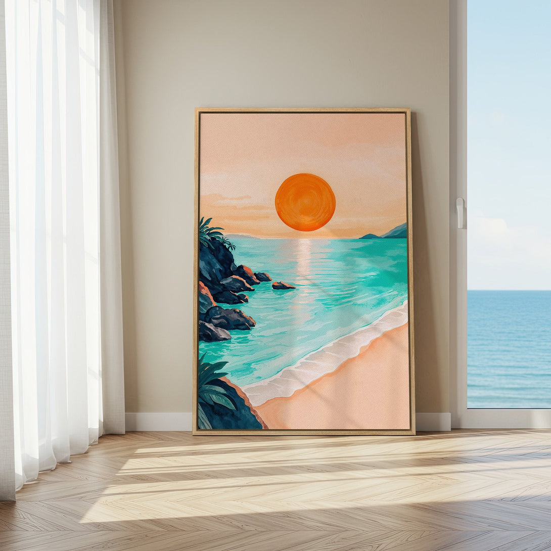 Framed Wall Art: Coastal sunset canvas print in a warm, inviting interior. Features a beach scene with turquoise water, orange sun, and a peachy color palette.