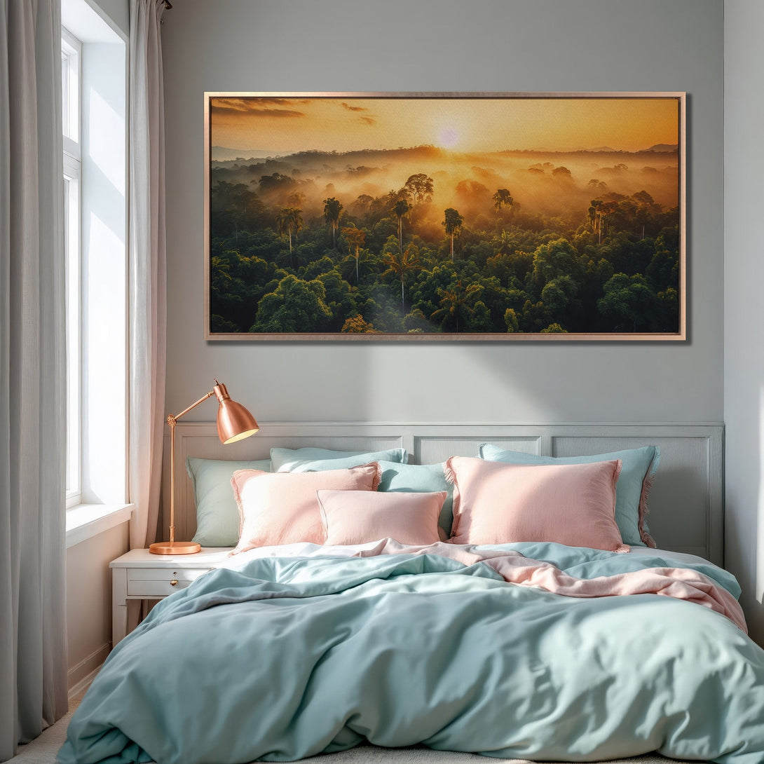 Framed Wall Art of a sunrise over a lush forest. Warm orange, green, and gold tones create a serene, nature-inspired aesthetic for your bedroom.