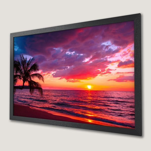 Framed Poster of a vibrant sunset over the ocean, featuring a palm tree silhouette. Rich red, orange, and purple hues.