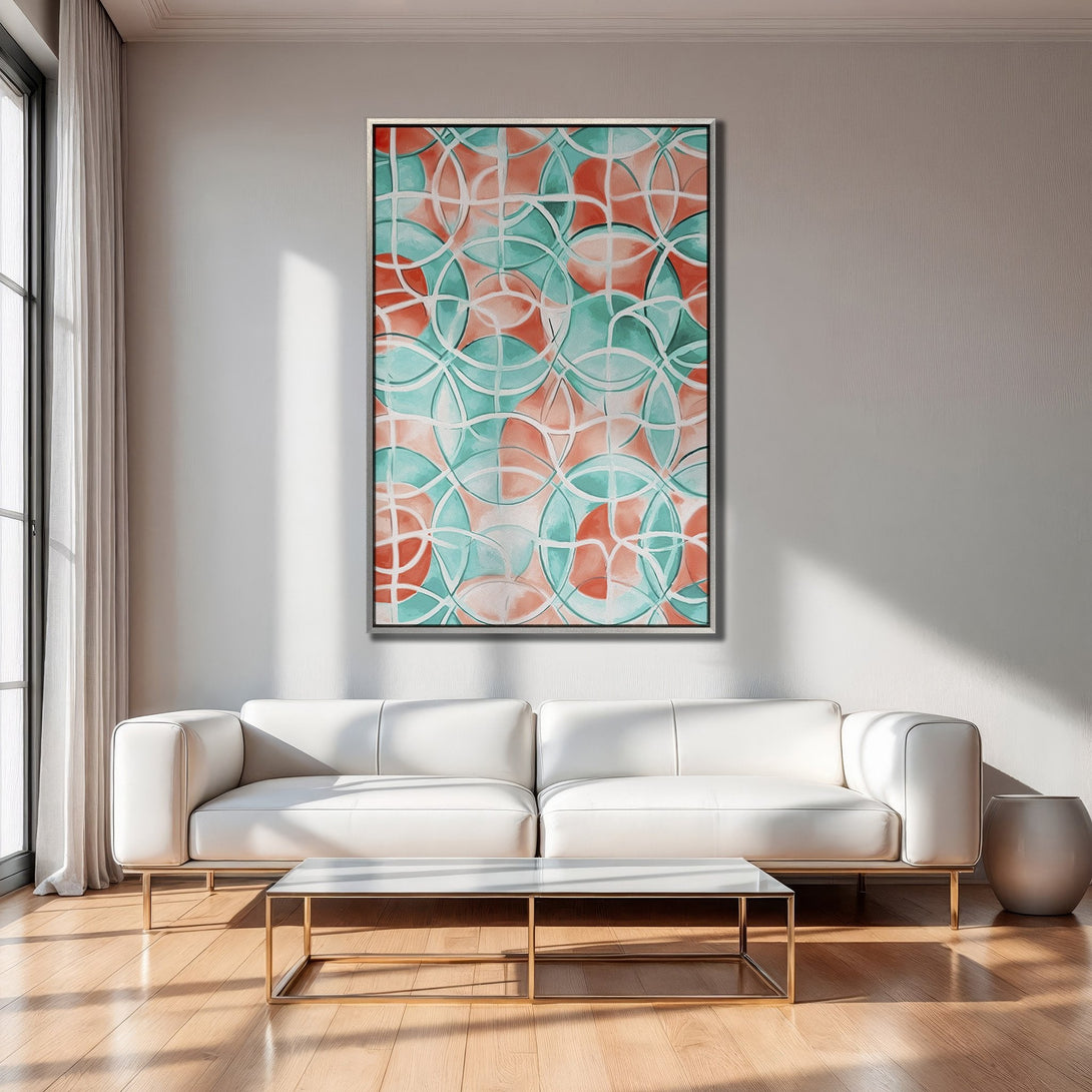 Framed Wall Art featuring an abstract geometric design in coral and teal. Modern artwork adds a pop of color to any living room.