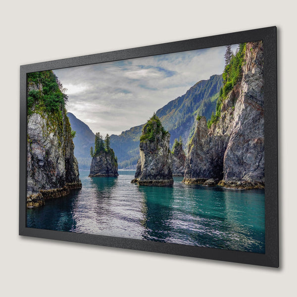 Framed Poster featuring a serene seascape with teal water and rocky islands. Nature-inspired art in a cool color palette.