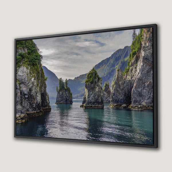 Framed Wall Art: Serene coastal landscape Canvas Print. Dramatic rock formations, teal water, and green foliage. Calming nature art for your home.
