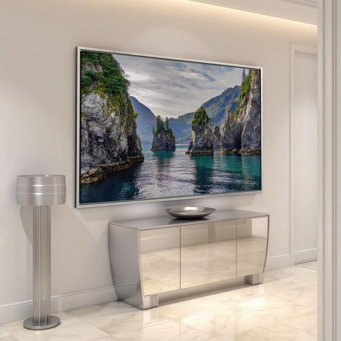Framed Wall Art: Stunning seascape Canvas Print in a modern interior. Featuring teal waters, rocky cliffs, and a cool, natural color palette. Elevate your space!