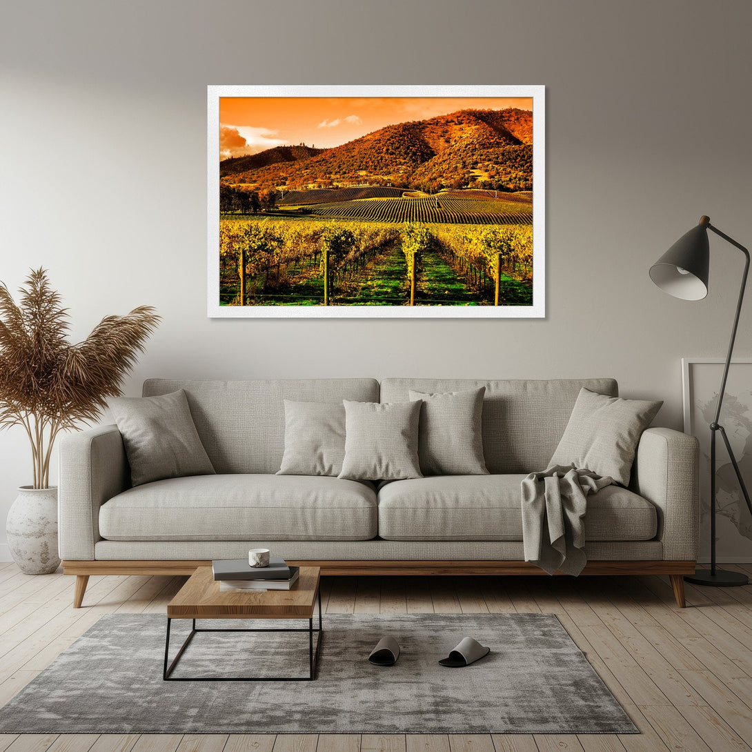 Framed Poster of a vineyard landscape in warm yellow and orange tones, perfect wall art for your home decor.