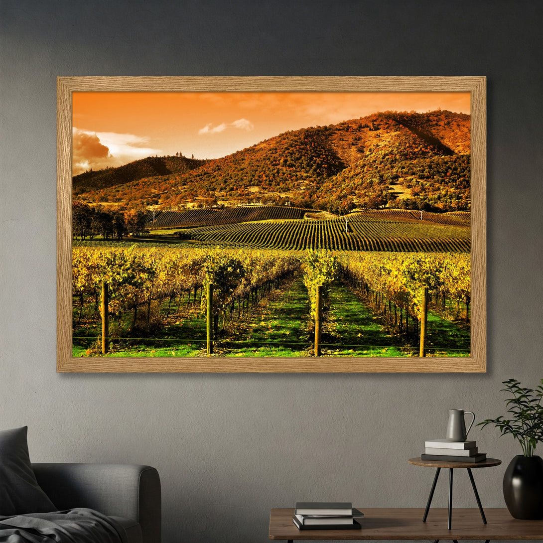 Framed Poster of a vineyard landscape in warm yellow and orange tones. Perfect wall art for a cozy home.